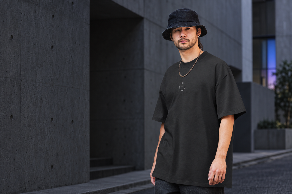 Model wearing the Reverse Cursed oversized faded tee in Faded Black